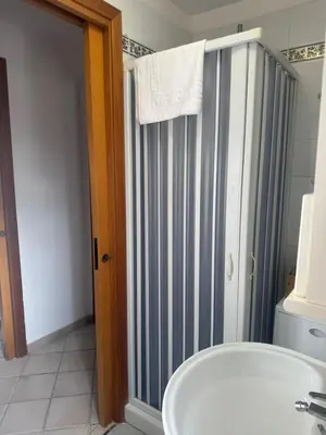 a bathroom with a shower and a white sink at Lulu' Home - Guidaloca - Scopello in Scopello
