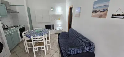 a kitchen with a table and chairs in a kitchen at Lulu' Home - Guidaloca - Scopello in Scopello