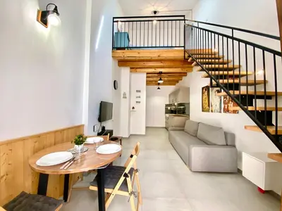 a living room with a table and a couch at Loft Pergola, posizione strategica in Castellammare del Golfo