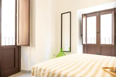 a bedroom with a bed with a vase on it at La suite al Teatro Massimo in Palermo
