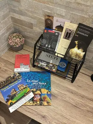 a pile of books sitting on top of a table at Mamma Chica Alloggio Turistico a Palermo in Palermo
