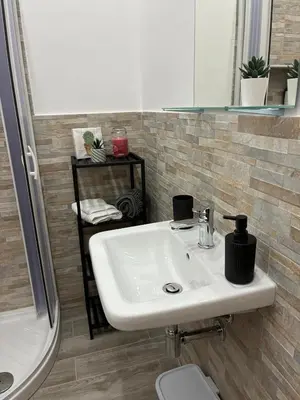 a bathroom with a white sink and a toilet at Mamma Chica Alloggio Turistico a Palermo in Palermo