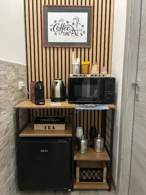 a kitchen with a microwave and a black refrigerator at Mamma Chica Alloggio Turistico a Palermo in Palermo