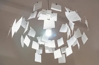 a chandelier made of papers hanging on a wall at Loft35 - Loft con Vasca Idromassaggio nel Cuore di Palermo 