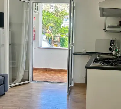 a kitchen with a sliding glass door to a patio at Charlotte in Palermo