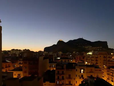 a view of a city with a mountain in the background at Cantieri 58 in Palermo