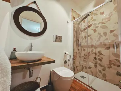 a bathroom with a sink and a toilet and a shower at Oxalis Rooms & Suite in Palermo