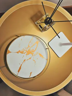 a gold table with a plate on top of it at Oxalis Rooms & Suite in Palermo