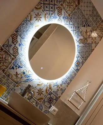 a bathroom with a mirror and blue tiles at Art suite palermo in Palermo
