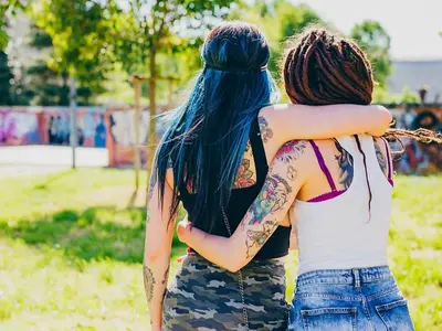 two girls with tattoos standing in a park at Art suite palermo in Palermo