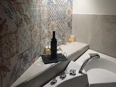 a bathroom with a bottle of wine on a sink at Art suite palermo in Palermo