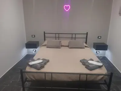 a bed in a room with two pillows on it at Suite Nobile in Palermo