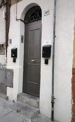 a black door on the side of a building at 30House in Palermo
