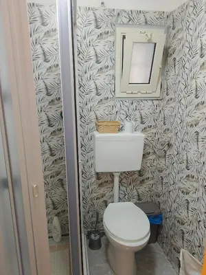 a bathroom with a toilet and a mirror at La casetta di Barbara in Palermo