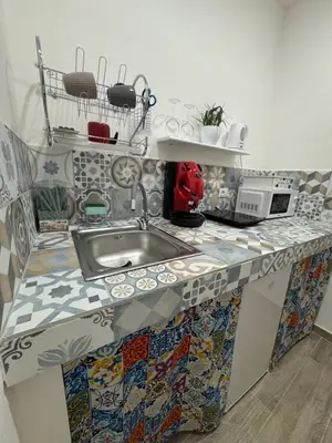 a kitchen counter with a sink and a microwave at Cristofarohome2 in Palermo