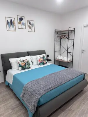 a bedroom with a large bed with blue sheets and pillows at Cristofarohome2 in Palermo