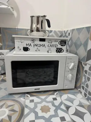 a microwave oven with a pot on top of it at Cristofarohome2 in Palermo