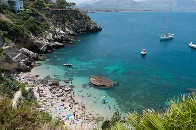 a group of people on a beach in the water at Casa Mirella in Aspra