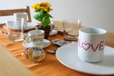 a table with a coffee cup and a plate on it at B&B Cala Peppa in Palermo