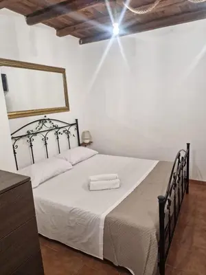 a bedroom with a white bed with a black frame at Al vicolo holiday home in Palermo