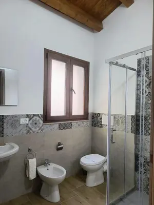 a bathroom with a toilet and a sink and a shower at La Casetta di Lilla in Palermo