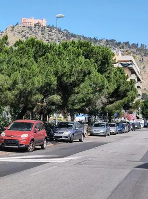 a row of cars parked on the side of a street at La Casetta di Lilla in Palermo
