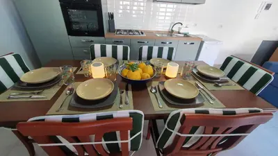 a dining room table with a bowl of fruit on it at Casa Nonna Rosa in Balestrate