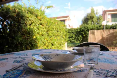a table with a bowl and a plate on it at Summer House in Buonfornello