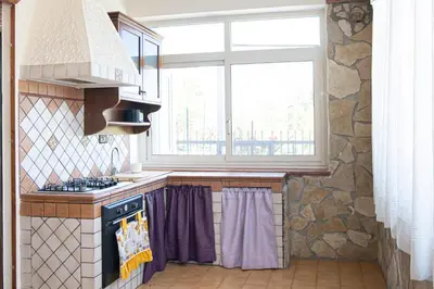 a kitchen with a stove and a window at Appartamento vicino Palermo - 2 bedr in Trabia in Trabia
