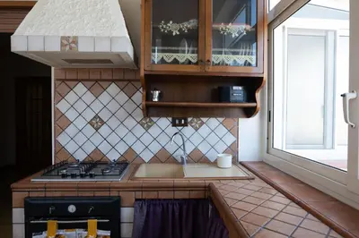 a small kitchen with a stove and a window at Appartamento vicino Palermo - 2 bedr in Trabia in Trabia
