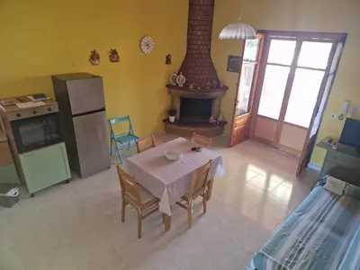 an overhead view of a kitchen with a table and a fireplace at Silville in Campofelice di Roccella