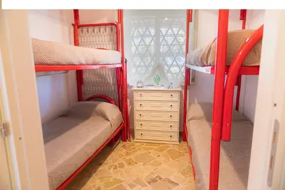 a room with two bunk beds and a dresser at villa ulivo rovetto in Mandra Capreria