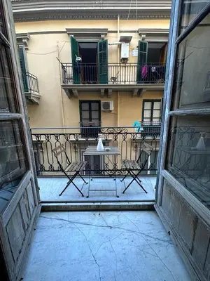 a view of a balcony with a table on a balcony at La finestra sugli archi in Palermo
