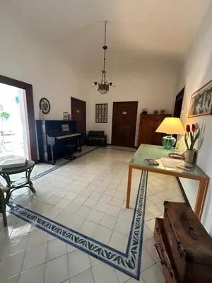 a living room with a table and a couch at La finestra sugli archi in Palermo