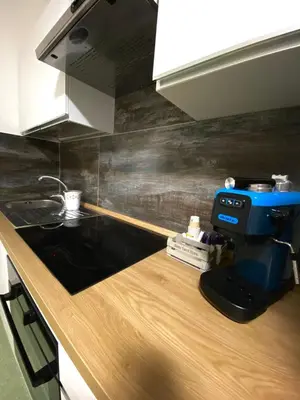a kitchen counter with a coffee maker on top of it at Casimiro in Porticello