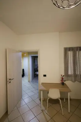 a dining room with a table and a chair at appartamento san felice in Bagheria