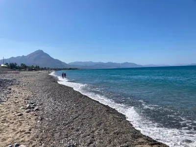 a group of people walking on the beach at Casa Marina in Buonfornello
