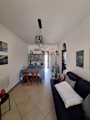 a living room with a couch and a table at Casa Marina in Buonfornello