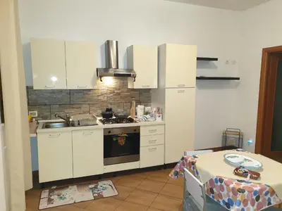 a kitchen with white cabinets and a stove top oven at CASA di VIA PITRE' 29 in Palermo