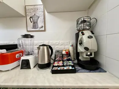 a kitchen counter with a coffee maker and a blender at Piccolo Brasile Home in Capaci