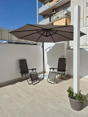 two chairs and an umbrella on a roof at ammare da mari in Castellammare del Golfo