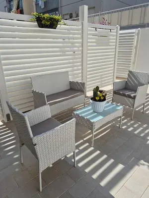 a patio with chairs and a table and a fence at ammare da mari in Castellammare del Golfo