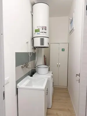 a washer and dryer in a white laundry room at Light Charme, Sun Light Apartment a due passi dalla PIAZZA DUOMO in Terrasini