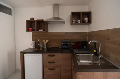 a kitchen with a sink and a counter top at A Calat'i Jurici in Palermo