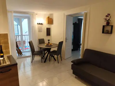 a living room with a table and chairs and a couch at A Calat'i Jurici in Palermo