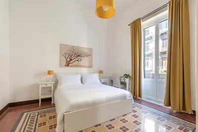 a kitchen with a wooden table and a small table at Casa Markea by Wonderful Italy in Palermo