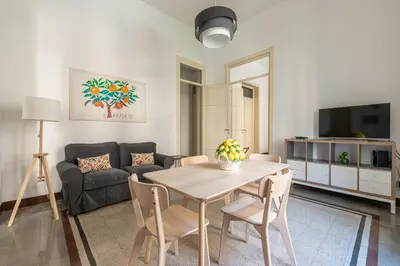 a kitchen with white cabinets and a table and chairs at Casa Markea by Wonderful Italy in Palermo