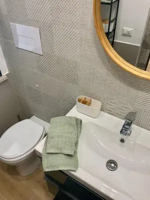 a bathroom with a sink and a toilet and a mirror at Due passi dal castello a mare in Castellammare del Golfo