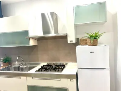 a kitchen with a white stove and a sink at Due passi dal castello a mare in Castellammare del Golfo
