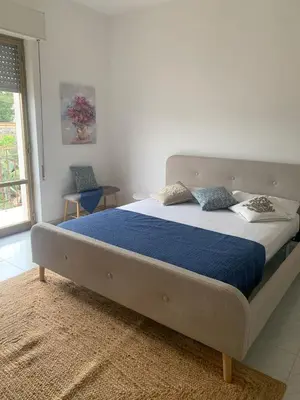 a bedroom with a large bed with a blue blanket at Appartamento Citreum in Balestrate